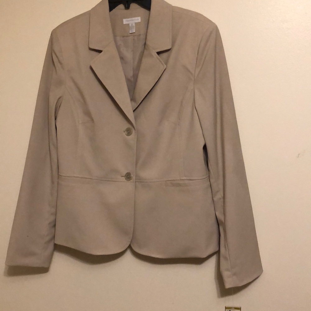 Tan jacket, mix of polyester, rayon and spandex. . Fully lined.